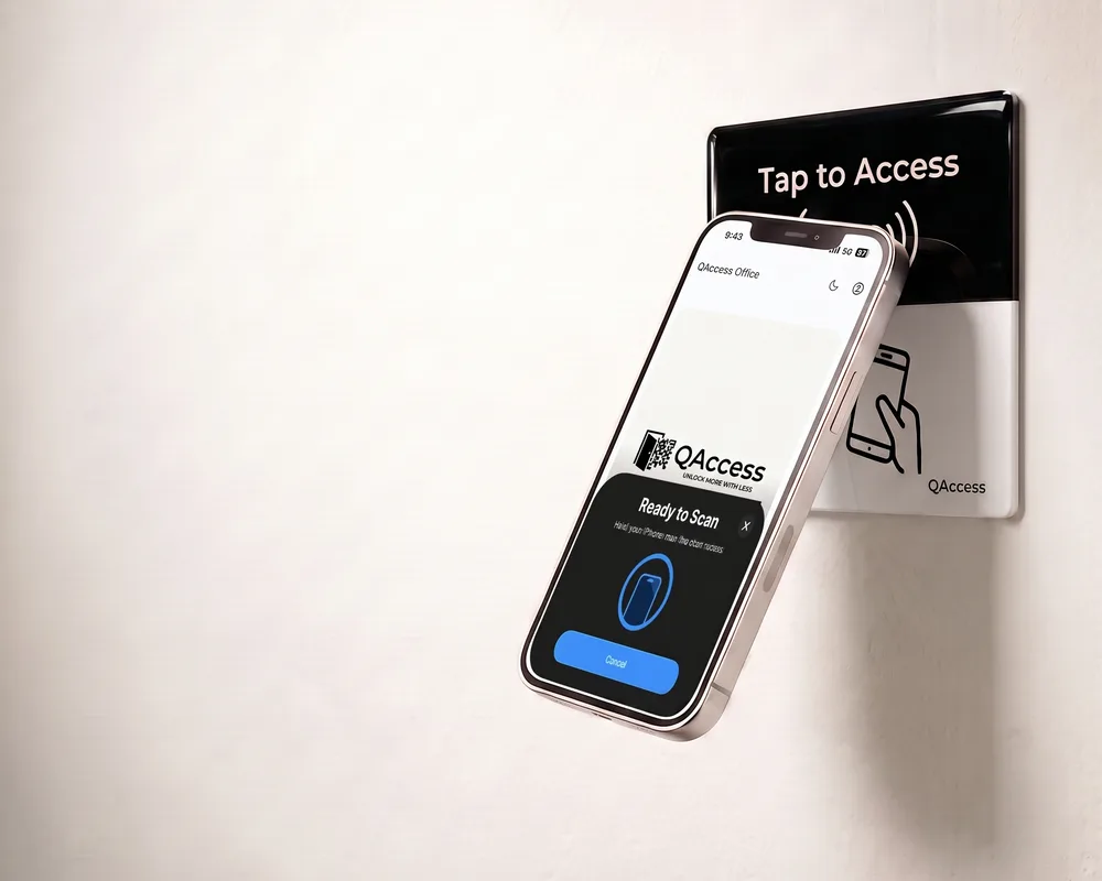 A phone held against a QAccess reader beside a door, showing the Ready to Scan prompt on screen.